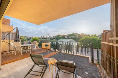 a patio with chairs and a table on a balcony at M REVASION Elegant Luxury Stays in the Center of Marrakech in Marrakech