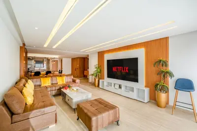 a living room with a couch and a tv at M REVASION Elegant Luxury Stays in the Center of Marrakech in Marrakech