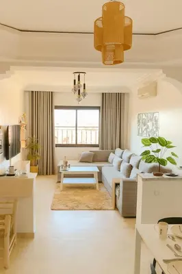 a living room with a couch and a table at Appartement Cosy Majorelle au Centre-Ville - Netflix-Fibre in Marrakech