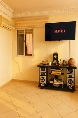 a living room with a television on the wall at Your favorite stay - 5min to M avenue & Gueliz in Marrakech