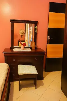 a dresser with a mirror and a stool in a room at Your favorite stay - 5min to M avenue & Gueliz in Marrakech