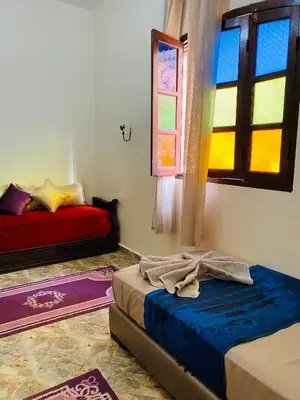a room with two beds and a window at Dar béa in Marrakech