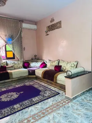 a living room with two beds and a couch at Dar béa in Marrakech