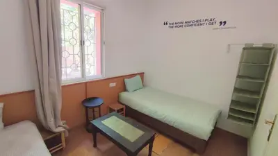 a small room with a bed and a window at MSC Hostel in Marrakech