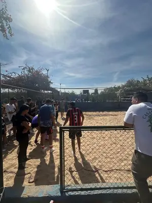a group of people standing behind a fence at MSC Hostel in Marrakech
