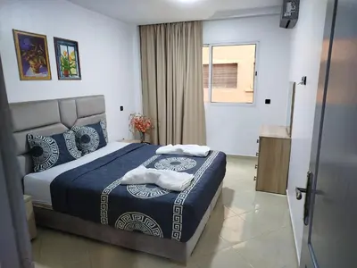 a bedroom with a bed with two towels on it at Fabuleux appartement au centre ville de Marrakech à Gueliz Gare CTM et Train in Marrakech