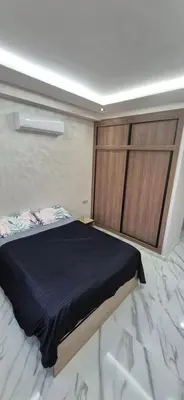a bedroom with a large bed and a sliding door at Havre de paix en plein Marrakech in Marrakech