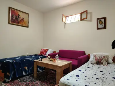 a living room with a couch and a table at غرفه هادئه في موقع رائع وقريبه من كولشي in Marrakech