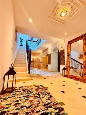 a living room with a staircase and a rug at Riad Kimee Room 3 in Marrakech