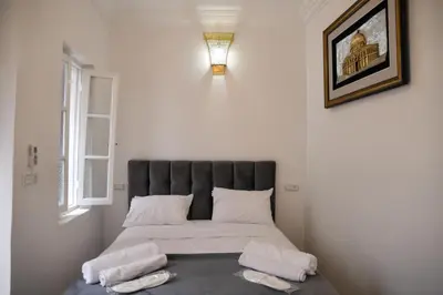 a bed in a room with two pillows on it at Riad Authentique en Exclusivité in Marrakech