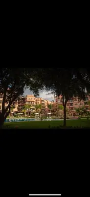 a view of a park with trees and a building at Appartement PREMIUM VILLAGE in Marrakech