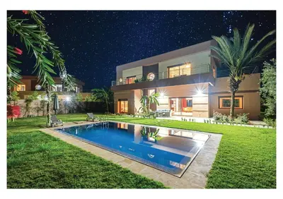 a house with a swimming pool in the yard at Villa Pivoine avec Jacuzzi, Cuisinière, Piscine in Marrakech