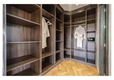 a walk in closet with wooden shelves at Villa Pivoine avec Jacuzzi, Cuisinière, Piscine in Marrakech