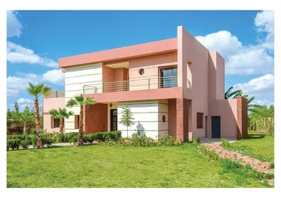 a house with a green lawn in front of it at Villa Pivoine avec Jacuzzi, Cuisinière, Piscine in Marrakech