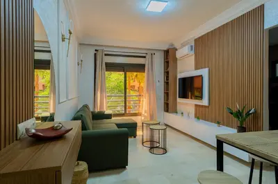 a living room with a couch and a table at Charment et spacieux 2 chambres avec salon in Marrakech