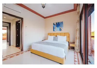 a bedroom with a large bed in a room at Villa Magnolia avec Jacuzzi, Cuisinière, Piscine in Marrakech