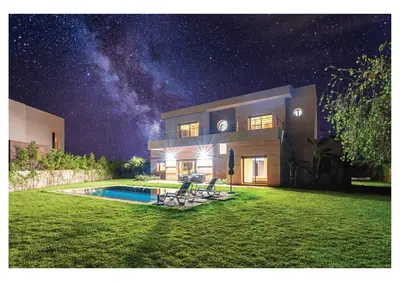 a house with a swimming pool at night at Villa Dahlia Jacuzzi, Stove, Pool in Marrakech