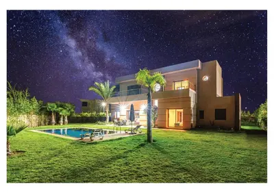 a house with a swimming pool at night at VILLA Lavande Jacuzzi, Cuisinière, Piscine in Marrakech