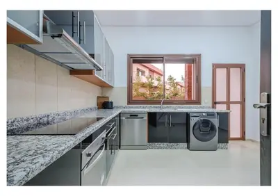 a kitchen with a washing machine and a window at VILLA Lavande Jacuzzi, Cuisinière, Piscine in Marrakech