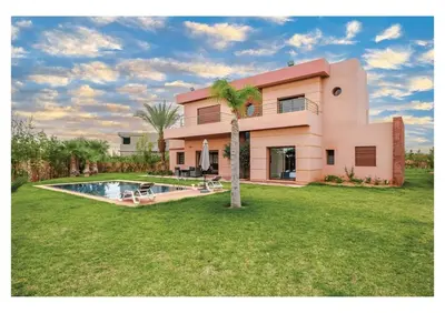 a large house with a swimming pool in the yard at VILLA Lavande Jacuzzi, Cuisinière, Piscine in Marrakech