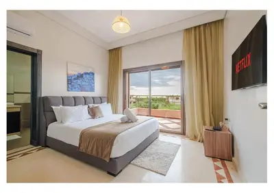 a bedroom with a large bed and a large window at VILLA Lavande Jacuzzi, Cuisinière, Piscine in Marrakech