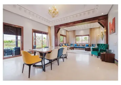 a dining room with a table and chairs at Villa Camelia avec Jacuzzi, Cuisinière, Piscine in Marrakech