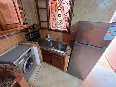 a kitchen with a sink and a refrigerator at Villa Ground Floor Rent Apt in Marrakech