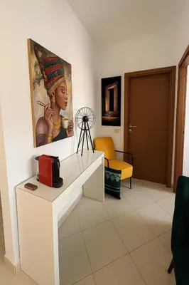 a living room with a painting on the wall at Appartement Moderne & Climatisé in Marrakech