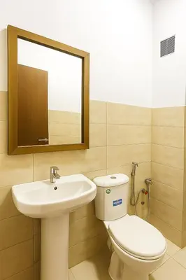 a bathroom with a sink and a toilet and a mirror at Appartement Moderne & Climatisé in Marrakech