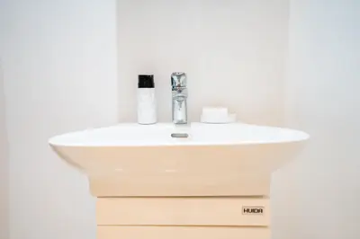 a white bathroom sink in a white wall at Appartement élégant avec jacuzzi à deux pas de Guéliz in Marrakech