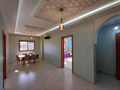 a dining room with a table and chairs and a bedroom at Villa Targa in Marrakech