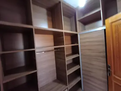 a closet with wooden shelves and a glass door at Villa Targa in Marrakech
