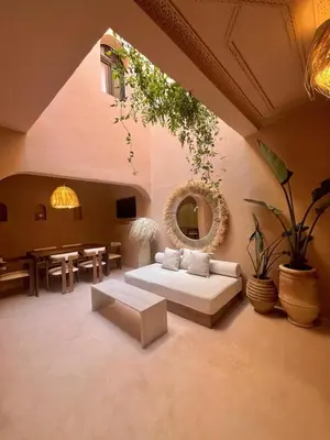 a living room with a couch and a table at Riad Roseli in Marrakech