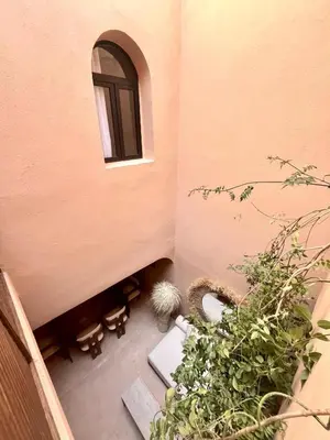 a small room with a window and some plants at Riad Roseli in Marrakech