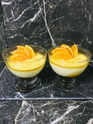 two glasses of orange juice with orange slices in them at Riad Mounir in Marrakech
