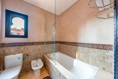 a bathroom with a bath tub and a toilet at Villa Palmera - 6 people - Pool - Marrakech in Marrakech