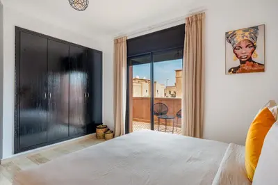 a bedroom with a bed and a large window at Villa Palmera - 6 people - Pool - Marrakech in Marrakech