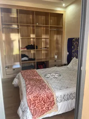 a bedroom with a bed with wooden shelves at Villa Marrakech in Marrakech