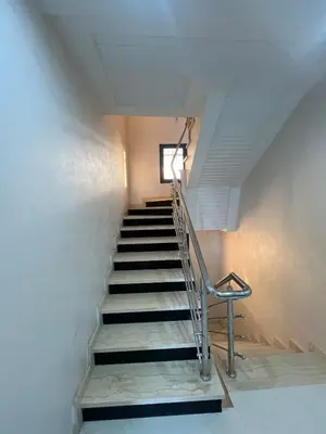 a staircase with a metal handrail and a window at Villa Marrakech in Marrakech