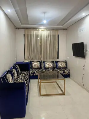 a living room with blue couches and a tv at Villa Marrakech in Marrakech