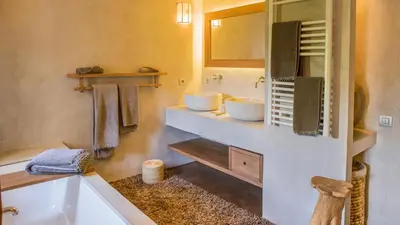 a bathroom with two white sinks and a tub at Dar-el-adaka in Marrakech