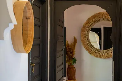 a hallway with a mirror next to a door at Villa Sidi Oasis in Marrakech