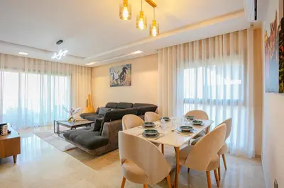 a living room with a table and a couch at The Garden Course - Marrakech - Prestigia in Marrakech