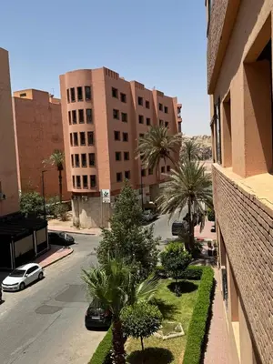 a view of a street from a building with palm trees at Sofia Palmeraie Appartement in Marrakech