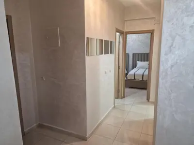 a hallway with a bedroom and a bed in a room at appartement mabrouka in Marrakech