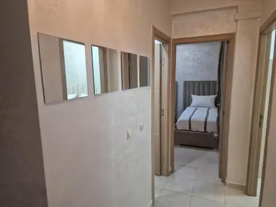 a room with a bedroom with a bed and windows at appartement mabrouka in Marrakech