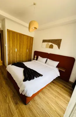 a bedroom with a large bed with white sheets at Noria Golf Marrakech in Marrakech