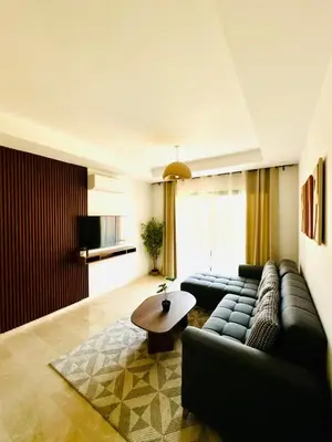 a living room with a couch and a table at Noria Golf Marrakech in Marrakech
