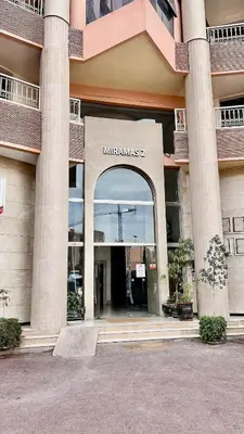 an entrance to a building with a sign that reads hotelamines at Appartement Miramas 2 E2 in Marrakech