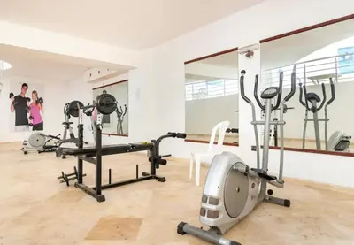 a gym with several treadmills and a mirror at Appartement Miramas 2 E2 in Marrakech